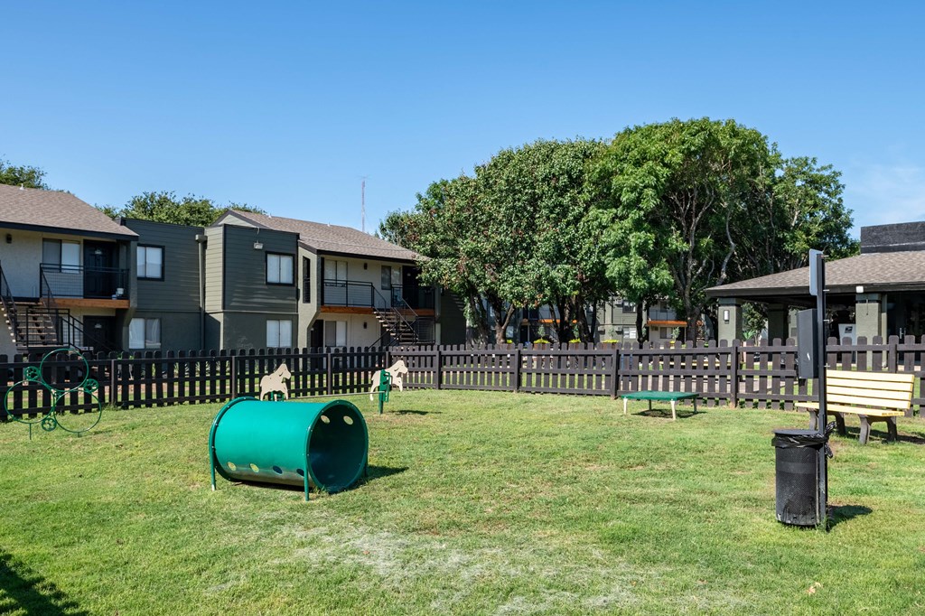 two children playing in a park in front of houses