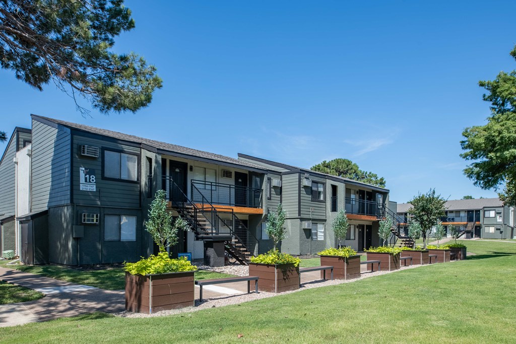 outside view of fusion fort worth apartment building with planter boxes and lawn