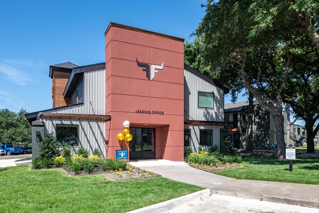 fusion fort worth apartments leasing office in Haltom City, Texas with green lawn and modern logo