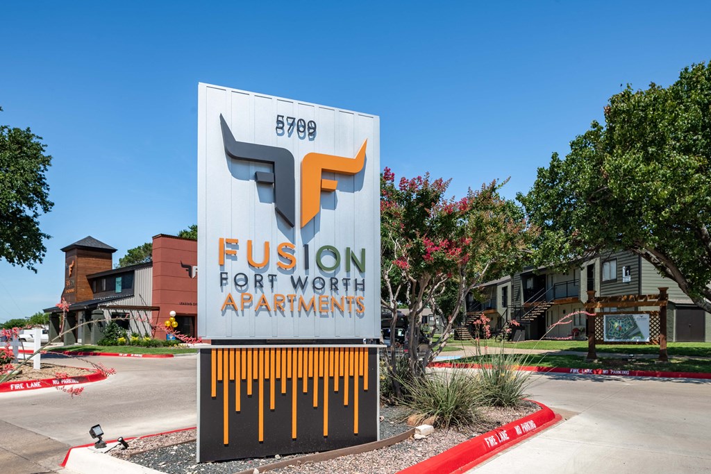fusion Fort Worth apartments monument sign with apartment logo and modern green and grey color scheme