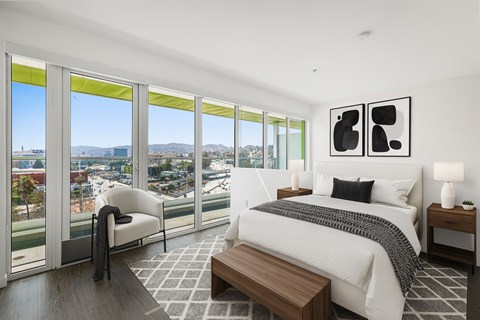 Fusion Hollywood bedroom with a large bed and a view of the city.