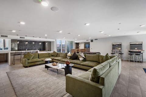 A living room with a large couch and a coffee table.