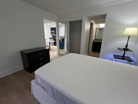 Fusion Orlando 1-bedroom with a large bed and a black dresser.