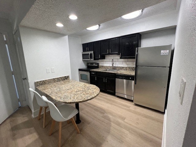 Fusion Orlando furnished apartments Orlando kitchen with a granite countertop and stainless steel appliances.