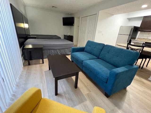 a living room with a couch and a table and a bed
