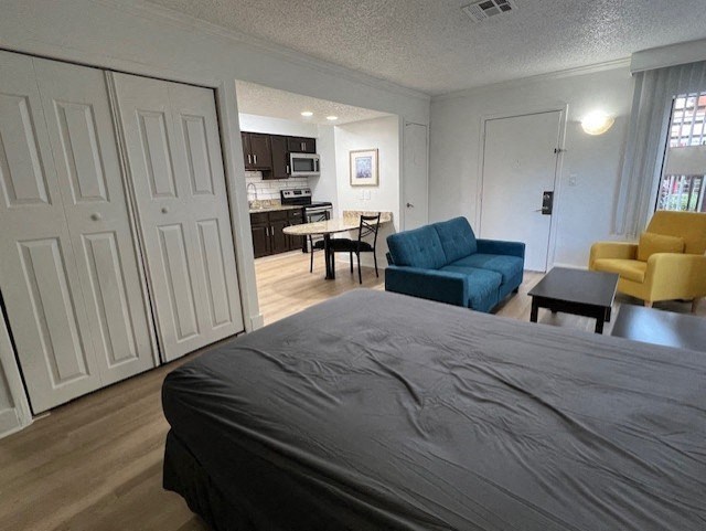 a bedroom and living room with a couch and a bed