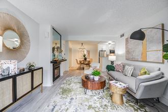 Apartments in Woodland Hills for Rent - Fusion Warner Center - Modern Living Room With Stylish Decor, Wood-Style Flooring, and Access to Dining Area