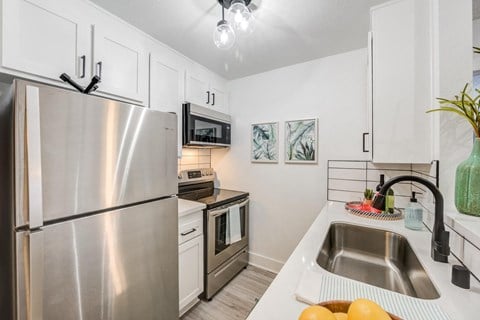 Apartments for Rent in Woodland Hills, CA - Fusion Warner Center - Kitchen With Stainless Steel Appliances and White Cabinetry