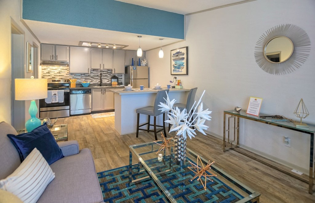 Open Concept living room and kitchen in the Retreat at Indian Lake in Hendersonville with modern glass coffee and console tables.