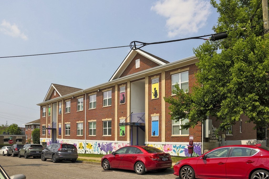 State Street Flats Apartment exterior with two entrances and street parking right next to building. Building has two stories and two entrances.
