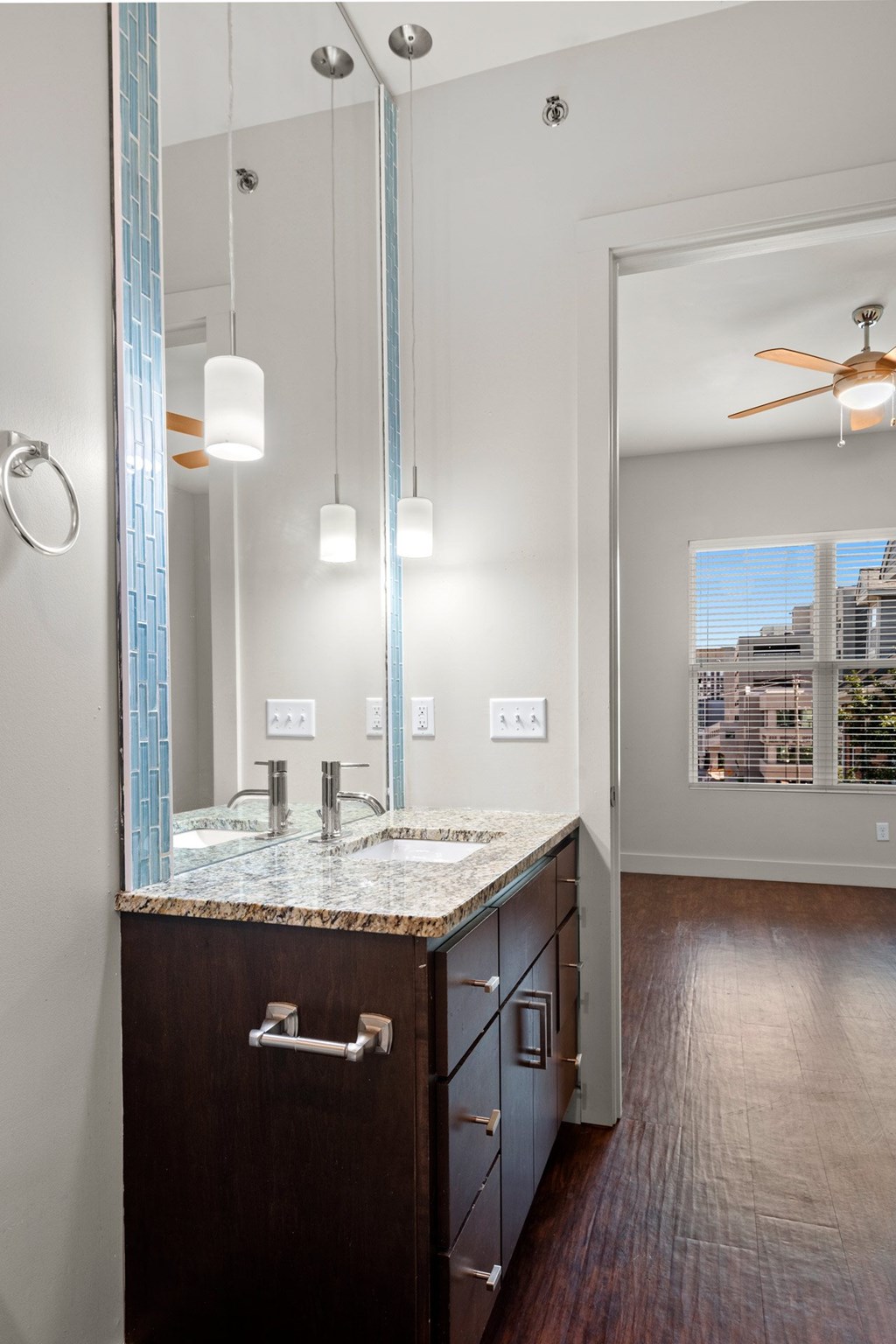 State Street Flats one bedroom apartments Nashville TN bathroom with a marble counter top and a large mirror.
