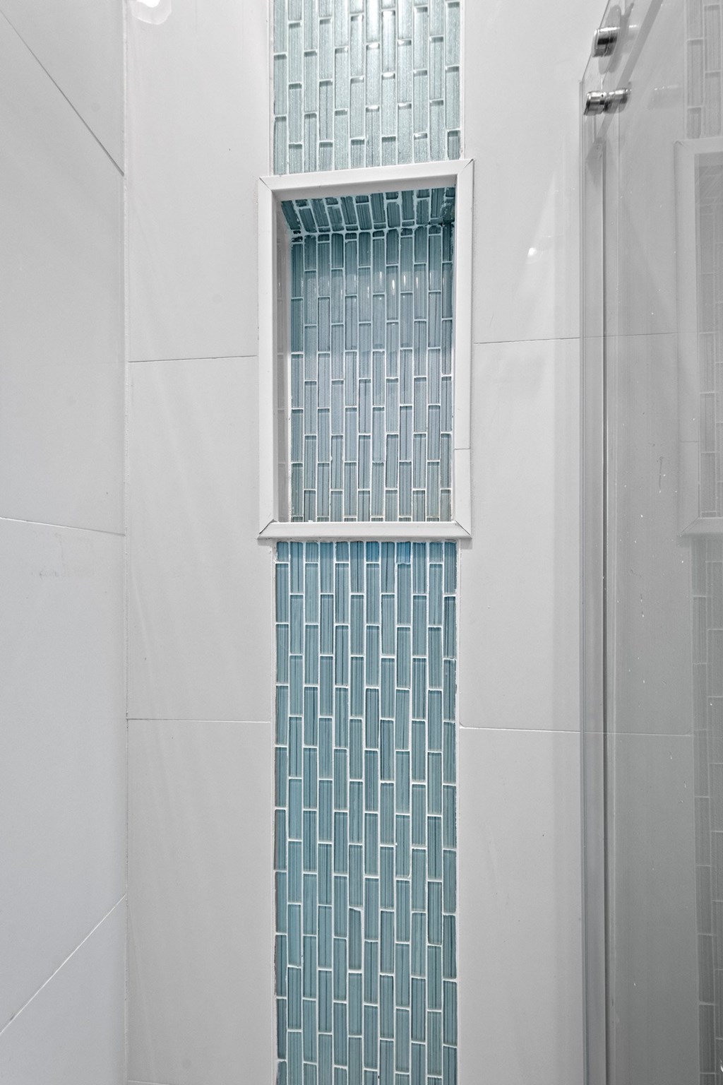 State Street Flats Apartments custom tile shower with a glass block wall.
