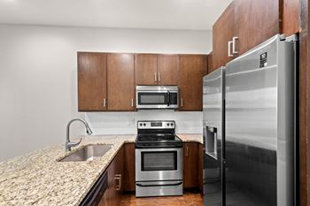 A kitchen with a stove, oven, and refrigerator.