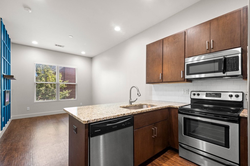 State Street Flats, city side flats apartments, kitchen with a stove, oven, dishwasher, and microwave.