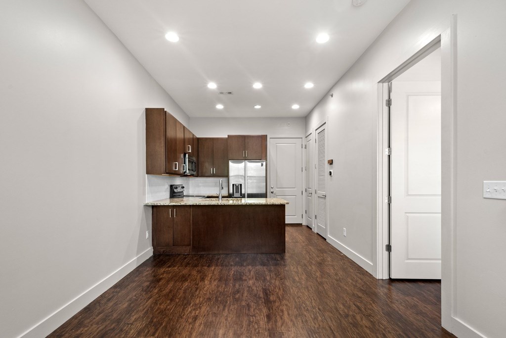 State Street Flats, apartments on State, kitchen with brown cabinets and a white countertop.