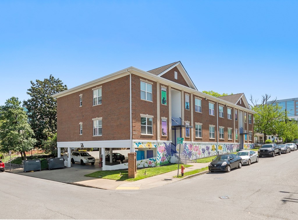 A street view of State Street Flats Apartments with a mural on the side - Nashville downtown apartments.