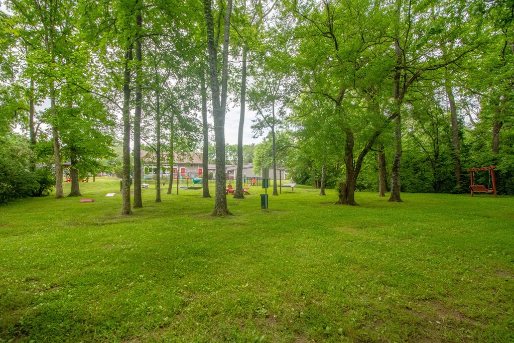 Retreat at Indian Lake Apartments park with green grass and trees.