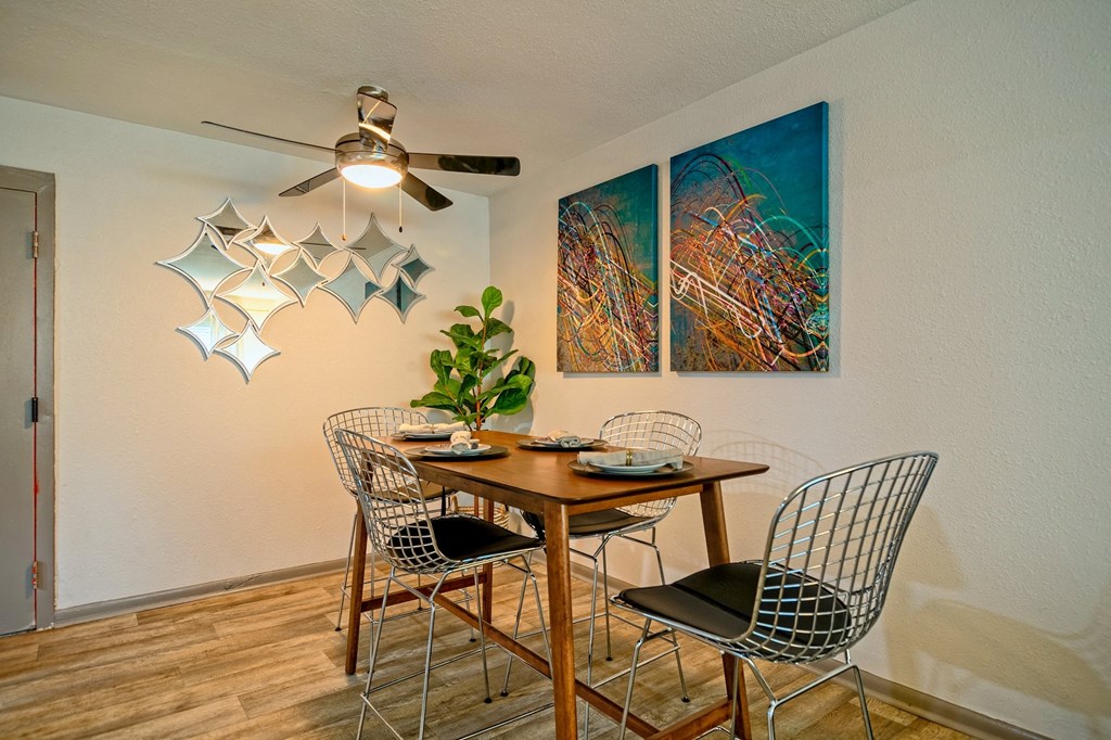 Dining Area Prime apartments in Nashville - dining area in the Canvas Apartments in Nashville, tn with modern ceiling fan, bar-height table, and two abstract canvas paintings.