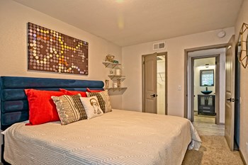 Apartments for Rent Nashville - The Canvas - Spacious Bedroom with Plush Carpeting, Stylish Decor, and a Closet - Photo Gallery 10