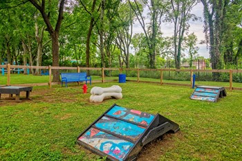 Apartments Nashville TN - The Canvas - Gated Bark Park with Obstacle Equipment, Bench Seating, and Lush Grass - Photo Gallery 18