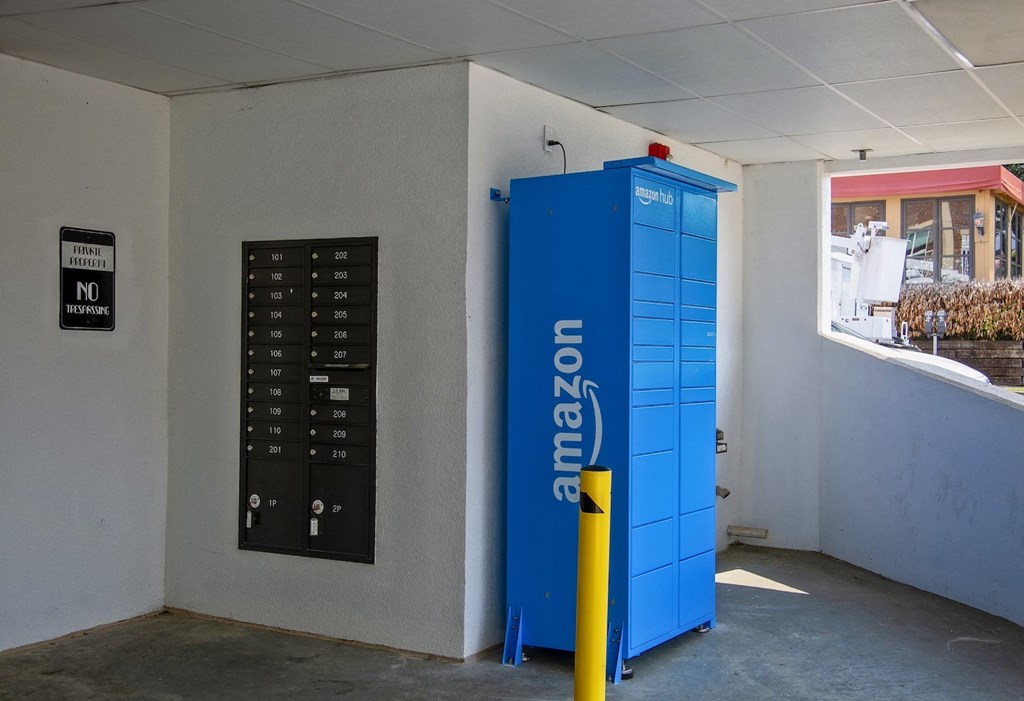 State Street Flats apartments in downtown Nashville mailboxes next to a blue amazon drop box and