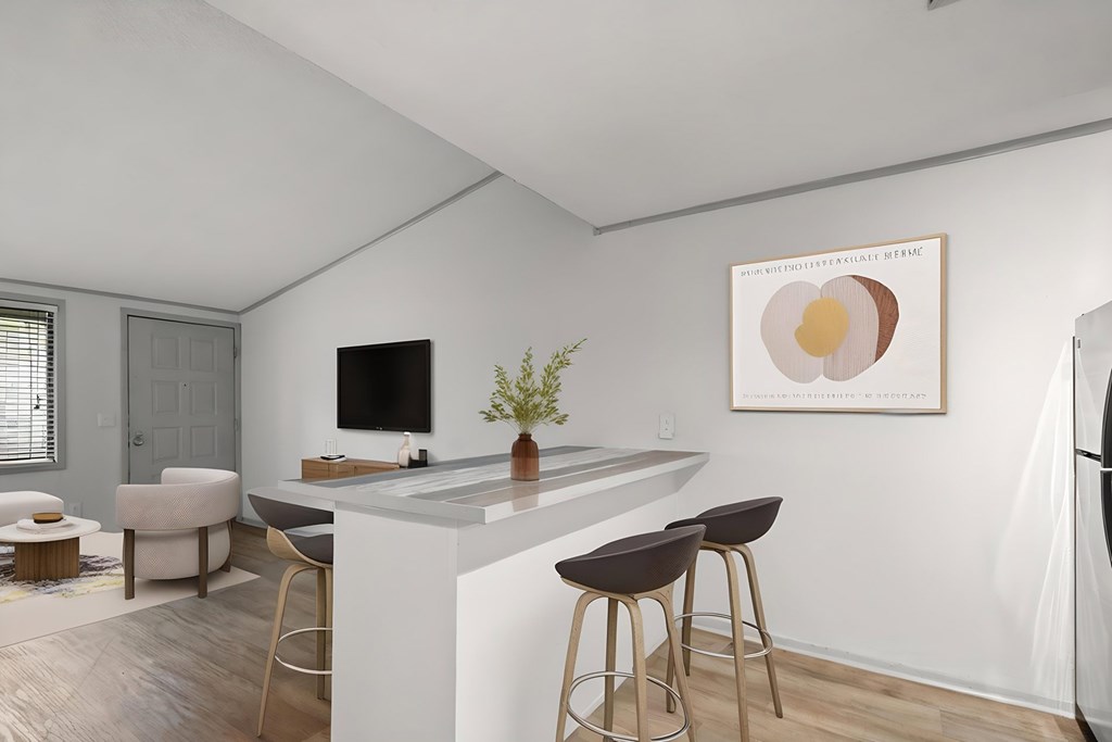 Retreat at Indian Lake apartments in Hendersonville, TN modern kitchen with a bar area and a framed artwork on the wall.