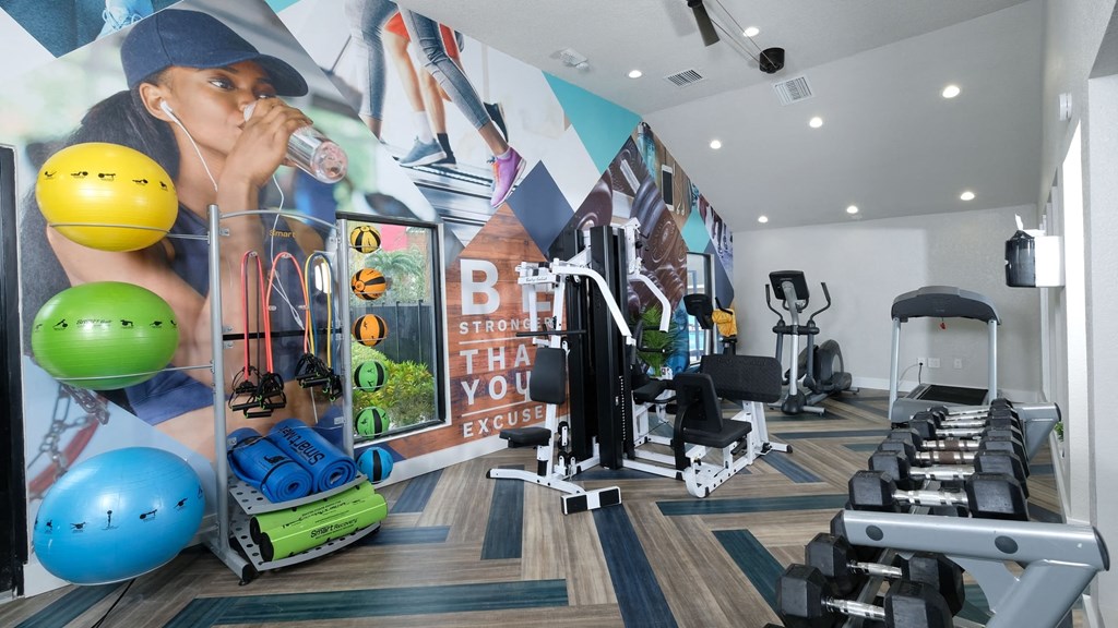 Fusion Orlando apartment fitness center with bodyweight equipment, cardio machines, and weight training equipment.