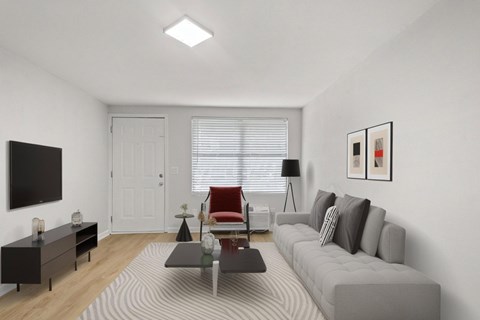 Retreat at Indian Lake apartments in Hendersonville, TN living room with a grey sofa, a red chair, a black table, and a white door.