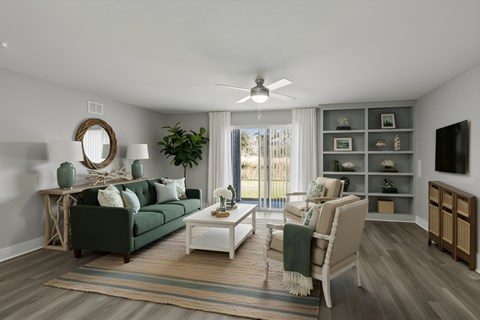 A living room with a green couch, a white coffee table, and a large window with a view of the outside at Mandarin Bay Apartments.