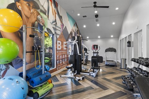Fusion Orlando fitness center with a variety of equipment and a motivational poster on the wall.