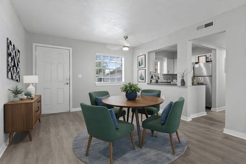 A dining room with a table and chairs at Watermarc Apartments.