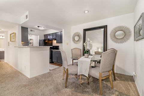 A dining room with a table set for two.