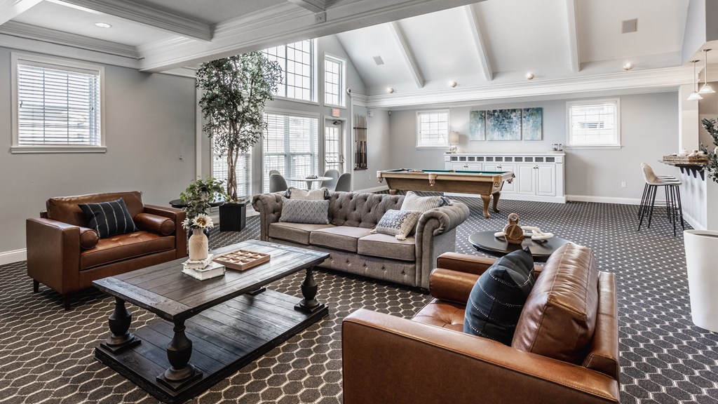 a living room filled with furniture and a pool table