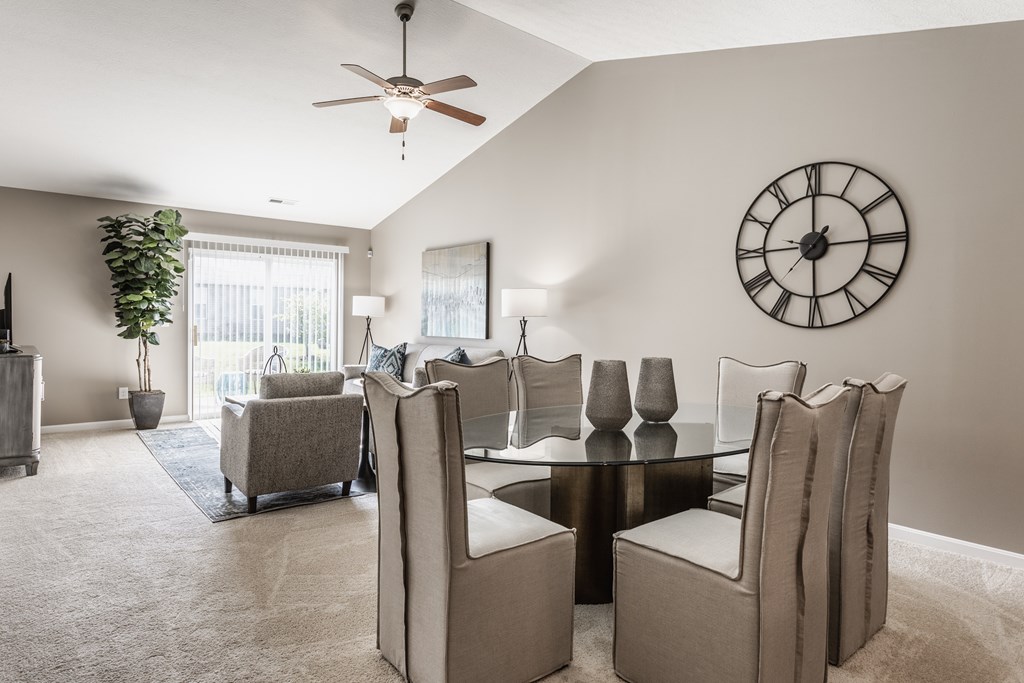 A living room with a dining table and chairs.