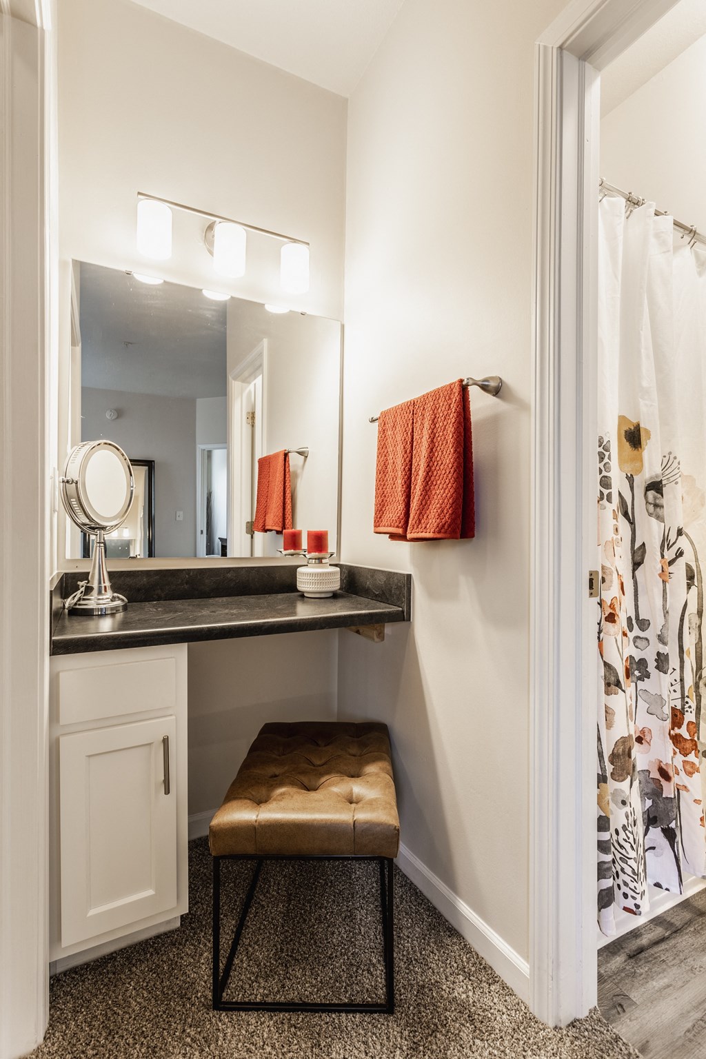 a vanity with a stool and a shower in a 555 waverly unit