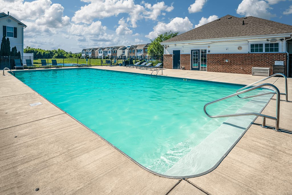 Pet-Friendly Townhomes in Pickerington, OH - Arbors at Turnberry - Sparkling Pool with Poolside Lounge Chairs and Gated Entry