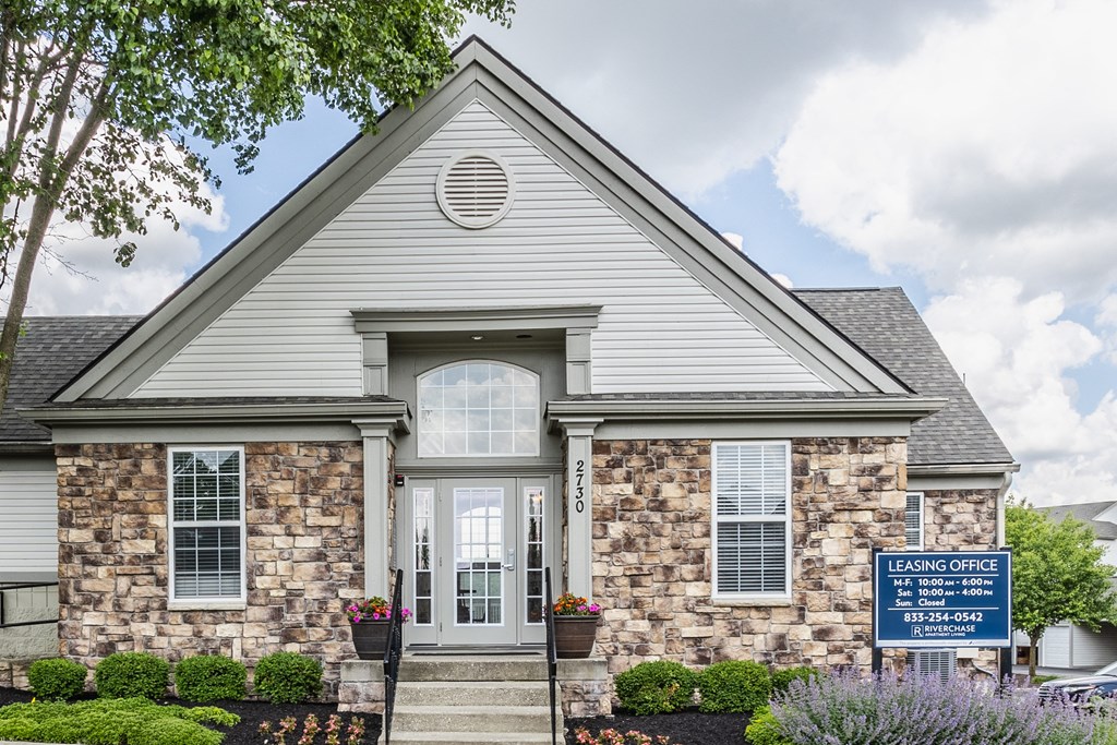 a home with a blue sign in front of it