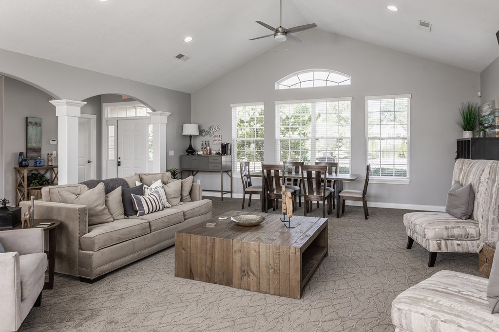 a living room filled with furniture and a large window