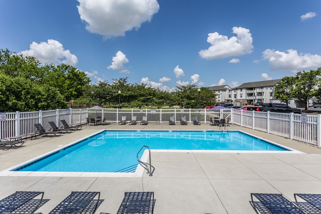 Indianapolis, IN Apartments - Riverchase - Sparkling Pool With Sundeck, Lounge Chairs, Tables With Umbrellas, And Apartment Homes In The Background