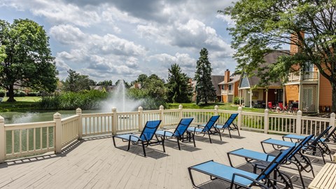 A selection of blue lounge chairs with a view of a fountain pond in Westerville, OH.