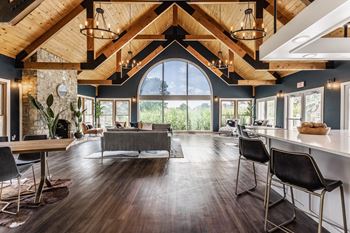 A modern living room with a large grey sofa and a wooden floor.