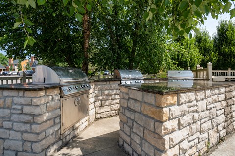A stone wall with a metal grill on top.