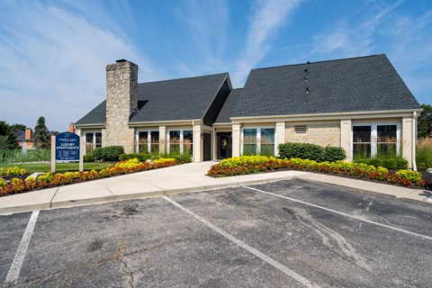 A building with a parking lot in front of it.