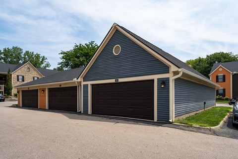 A two-car garage with a circular window above the left door.