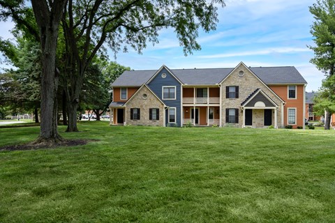 A large house with a tree in front of it.