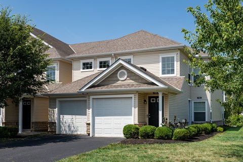 A house with a brown roof and a white garage door.