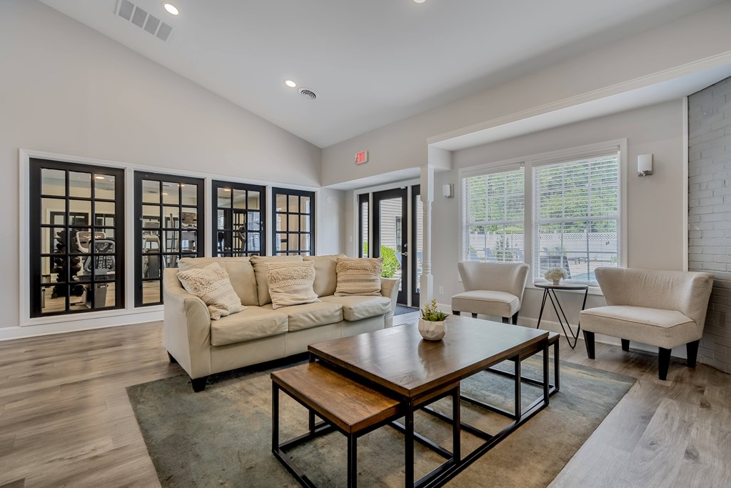 A living room with a white couch and a coffee table.