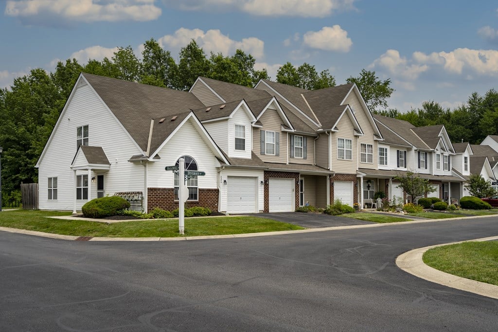 A row of houses with a street in front.