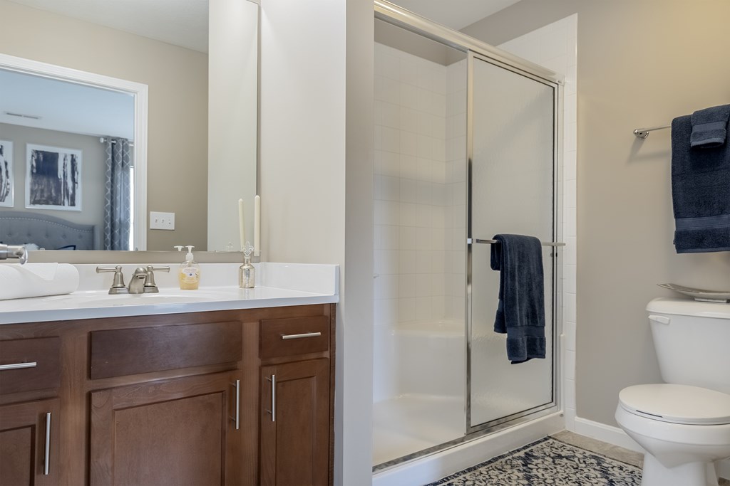 A bathroom with a white sink and a toilet.