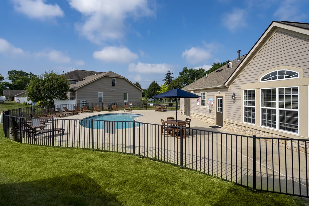 A house with a pool and a fence.